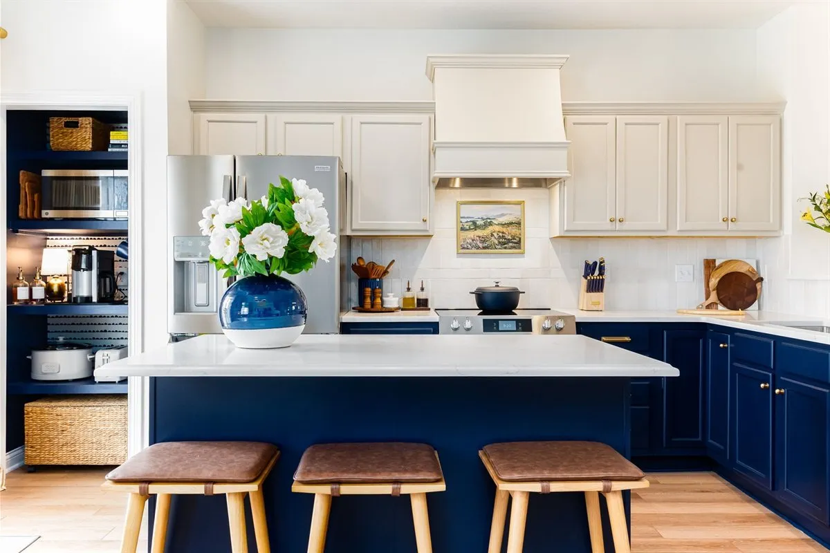 Kitchen with a navy island and open shelving